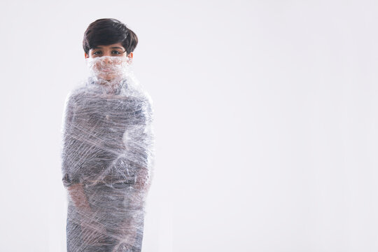Young boy wrapped in plastic from face to toe unable to breathe. (Children) 