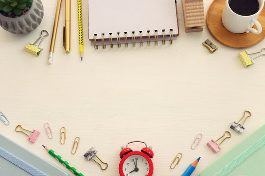Top view image of table with coffee and office supplies