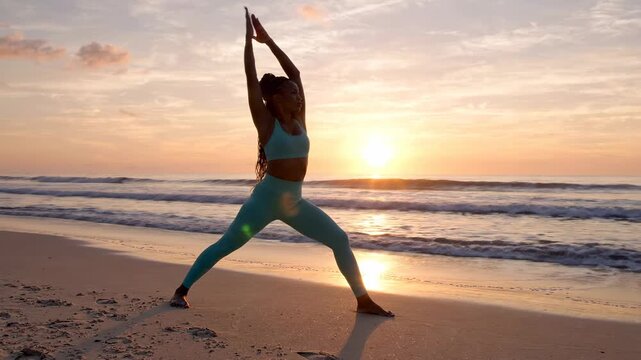 Woman practicing tai chi on sandy beach at sunset, mindful movement and serenity, calm ocean waves, golden hour light
