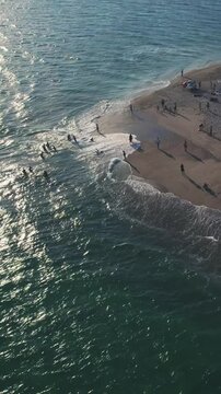 Aerial view of people enjoying sunset on Possidi Cape beach Halkidiki Greece