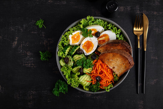 Healthy Breakfast Bowl with Eggs, Vegetables and Sourdough Bread. Top view