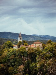 Fototapeta premium Hilltop Village Beneath Dramatic Storm Clouds in Slovenia
