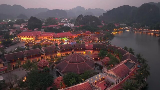 Aerial view of Tam Coc, a Historic Old Town Island in evening, Surrounded by Carst Mountains in Ninh Binh, Vietnam.