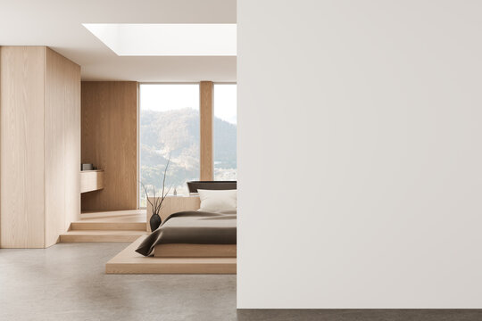 Minimal interior bedroom with wooden accents, large windows and spacious empty wall serving as clean poster mockup display design template for layout. 3D Rendering