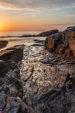 Beautiful stunning colorful vibrant Summer sunset at Trebarwith in Cornwall England