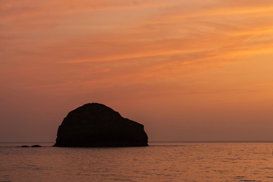 Stunning beautiful colorful vibrant Summer sunset at Trebarwith in Cornwall England