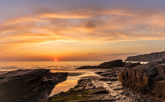 Beautiful stunning colorful vibrant Summer sunset at Trebarwith in Cornwall England