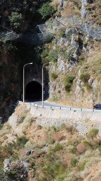 Vertical video of the road with tunnel through the Topolia Gorge canyon. Crete. Greece