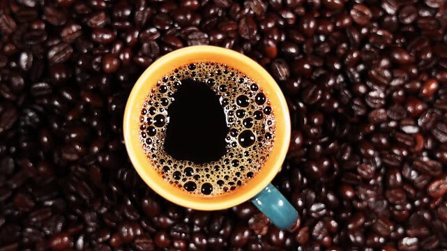 Coffee cup with fresh coffee on coffee beans 4K stock video
