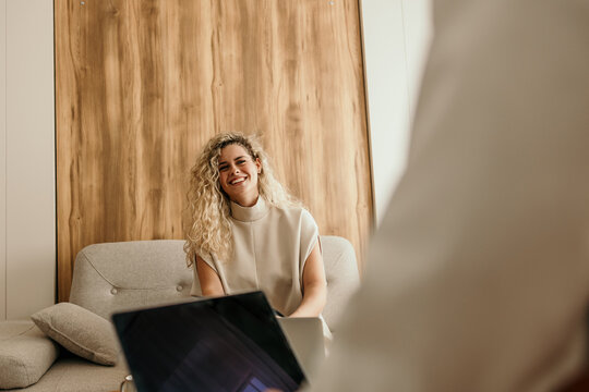 Happy woman smiling during informal business meeting collaboration