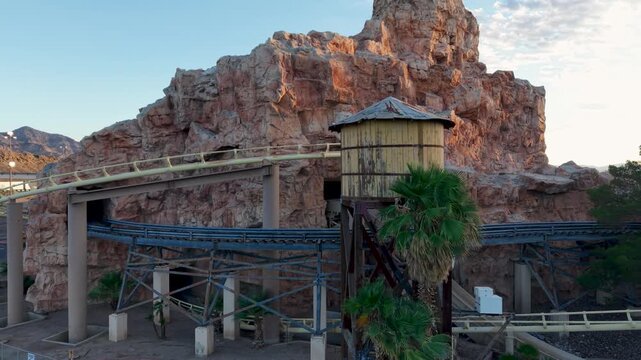 Dramatic slow orbit around the water tower and section of track of the Abandoned Desperado Roller Coaster at the Ca Nevada state line.