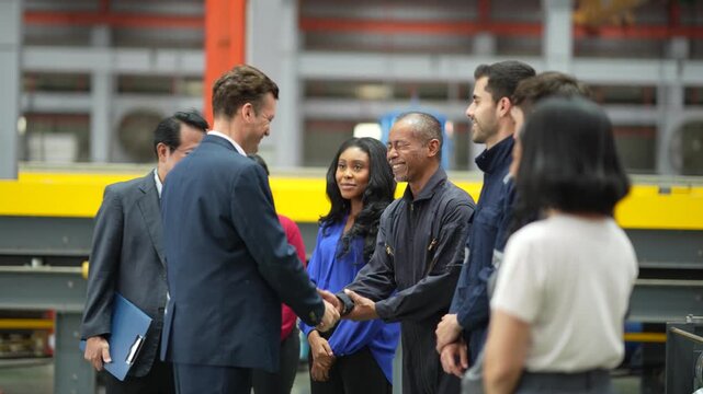 Business executive meeting factory engineers with handshake, manufacturing operation, industrial workforce, production facility, professional partnership, team cooperation.