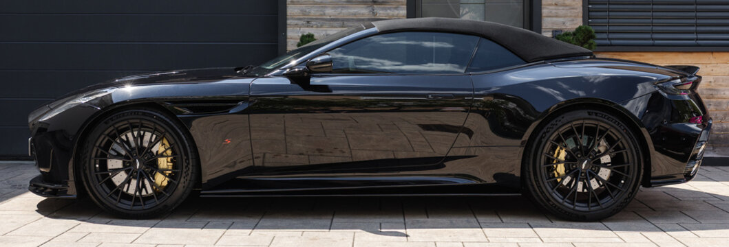 Ljubljana, Slovenia - 25 June 2026: Aston Martin DB12 S parked outside a modern building highlights premium features and sleek lines.