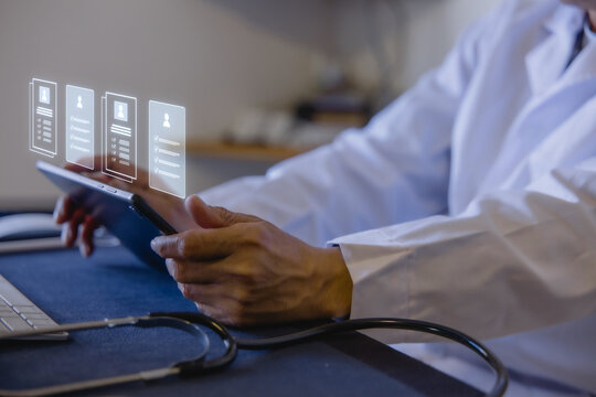 Doctor reviewing electronic medical records on tablet with digital patient profiles in a modern clinic. Healthcare technology