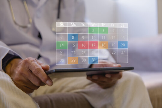 Doctor managing digital appointment calendar on tablet in a modern clinic. Healthcare scheduling patient management, medical planning electronic records telemedicine and workflow efficiency.