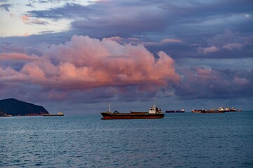 Cargo Ships Anchored off the Coast of Busan Beneath Dramatic Sunset Clouds, South Korea © Aleksandr Degtiarev