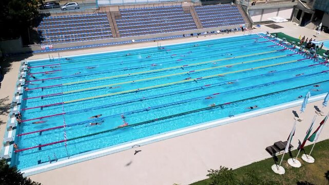 Aerial View of Outdoor Sports Swimming Pool Complex with Swimmers
