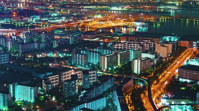 Osaka City Skyline Night Timelapse Aerial View Featuring Glowing Highway Traffic and Dense Residential Apartment Complexes Under Vibrant Urban Nighttime Lighting 4k Video