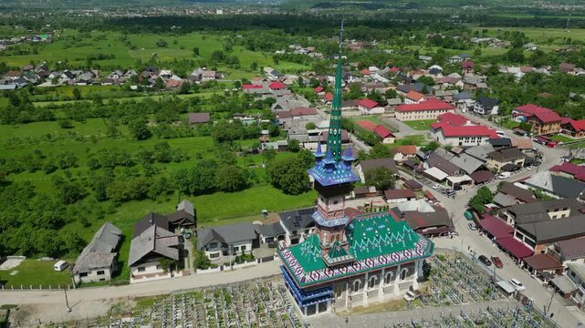Aerial perspective of the Merry Cemetery, a unique open air museum in Sapanta, Romania. Colorful church and wooden crosses in a beautiful valley