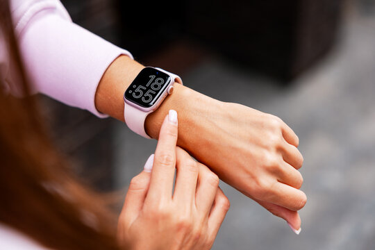 Woman wearing smartwatch using smart tracking technology