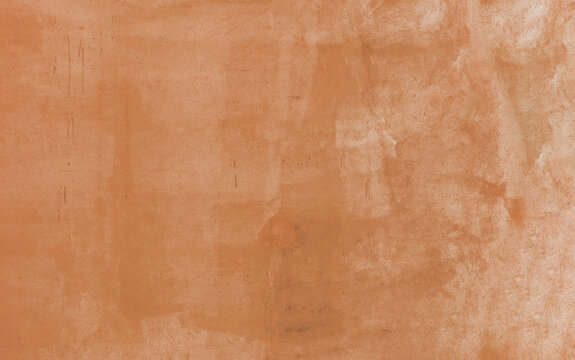 Warm terra cotta orange painted wall background showcasing a softly mottled stucco texture and subtle surface scratches, ideal for vintage-inspired graphic design and overlay projects.