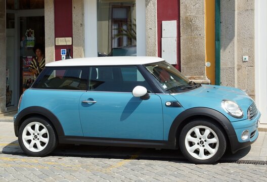 Blue Mini Cooper car parked on city street