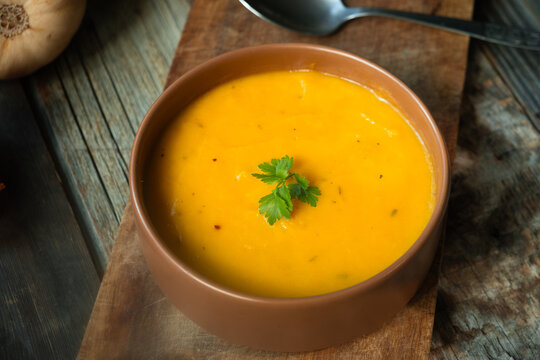 Bowl of pumpkin soup. Tradition autumn food, vegetable cream soup. Thanksgiving dinner in rustic style