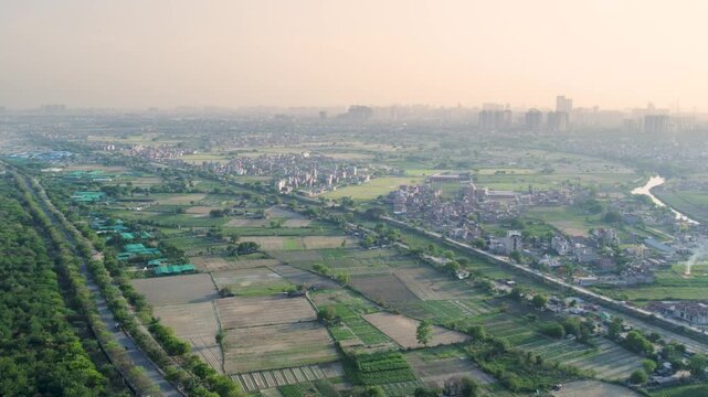 Aerial view of Delhi NCR landscape. Urban sprawl and green fields in Noida and Ghaziabad area.