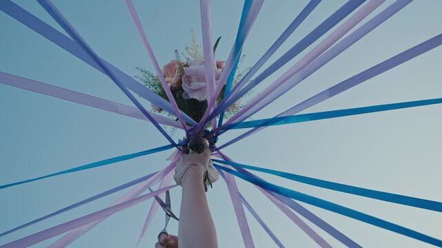 Colorful Wedding Ribbons Converging Around Bridal Bouquet