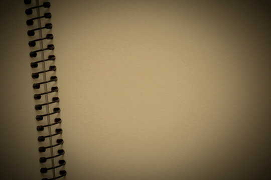 aged backdrop: close up of blank page of notepad with spiral binder