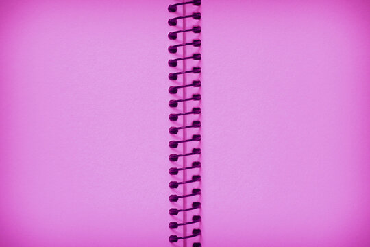 blank backdrop with shadowed edge: close up of pink diary spread