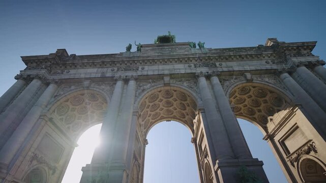 Sun shining through Brussels Belgium Triumphal Arch in Parc du Cinquantenaire