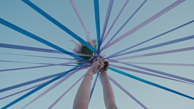 Wedding Ribbon Tradition with Bouquet Raised Toward the Sky