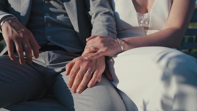 Wedding Rings on Bride and Groom Hands in Sunlight