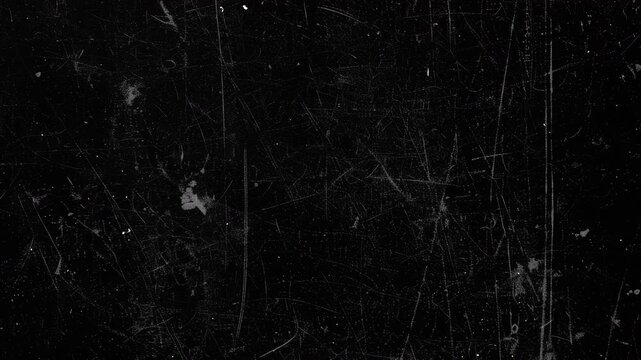 Abstract dark black texture with subtle film scratches and dust particles.