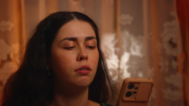 Portrait of a young Caucasian woman using a smartphone with an irritated and dissatisfied expression. Digital frustration, technology problems, online communication issues, and negative emotions
