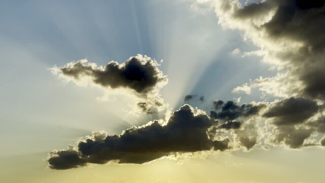 Evening cloudy sky, time before sunset. Clouds have blocked the sun, and rays of sunlight struggle to break through the dark clouds.