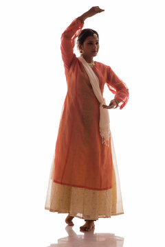 Graceful Kathak dancer giving a mesmerising performance in front of a white background. 