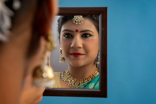 Kathak dancer looking at herself in the mirror. 