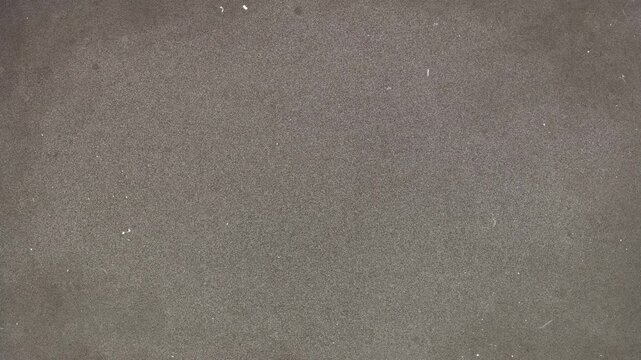 Abstract dark brown concrete wall texture with subtle rough surface details.