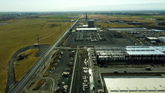 US, Oregon, Hermiston, 2026-05-27 - Drone view of an Amazon Data Center under construction with power lines running to it, in Summer