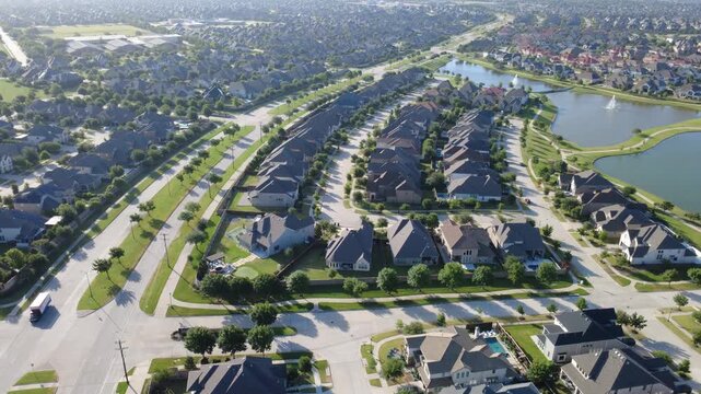 Busy multi lane roadways divide residential subdivisions from open natural terrain in Dallas Fort Worth metroplex. Master planned community designs define modern landscape growth in West Frisco