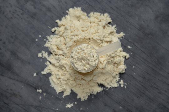 Protein powder scoop and pile, top view