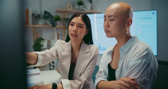 Young Asian business colleagues discussing project on computer at office. Corporate teamwork meeting, marketing report analysis, strategy planning development, professional manager advice concept.