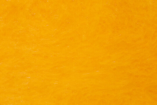 orange color backdrop: close up of pumpkin pulp texture