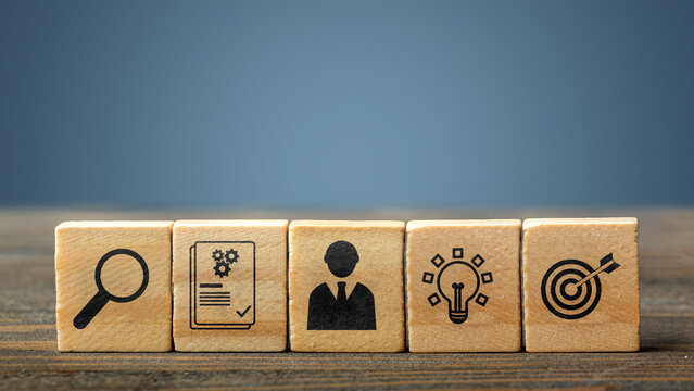 A row of five wooden cubes featuring icons representing search, documentation, management, innovation, and goals for corporate or business strategy themes. Concept of Recruitment Qualification