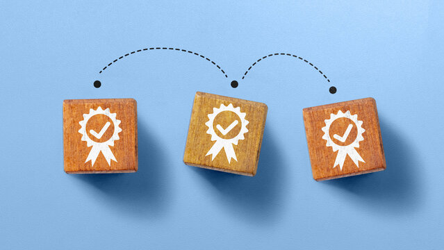 Three square wooden blocks featuring a white quality badge icon with checkmark, arranged in a row with curved dashed arrows connecting on a light blue background. Concept of Recruitment Qualification