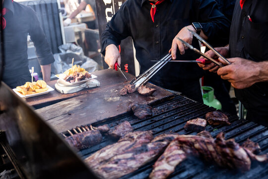 Some excellent pieces of Argentinian beef on a charcoal grill being prepared at open kitchen street food festival in Ljubljana, Slovenia