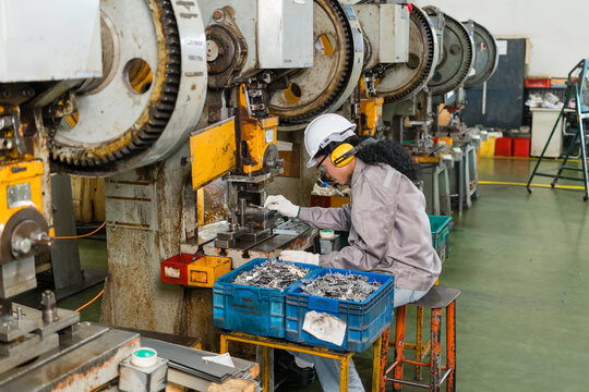 Female Operator Setting Stamped Metal Part Into Power Press Die Machine