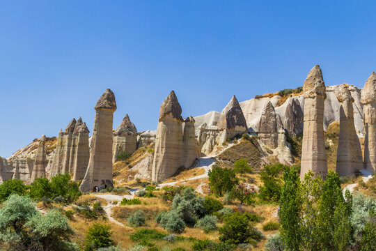 Fairy chimneys in Love Valley, Cappadocia. Hiking adventure and sustainable travel concept.